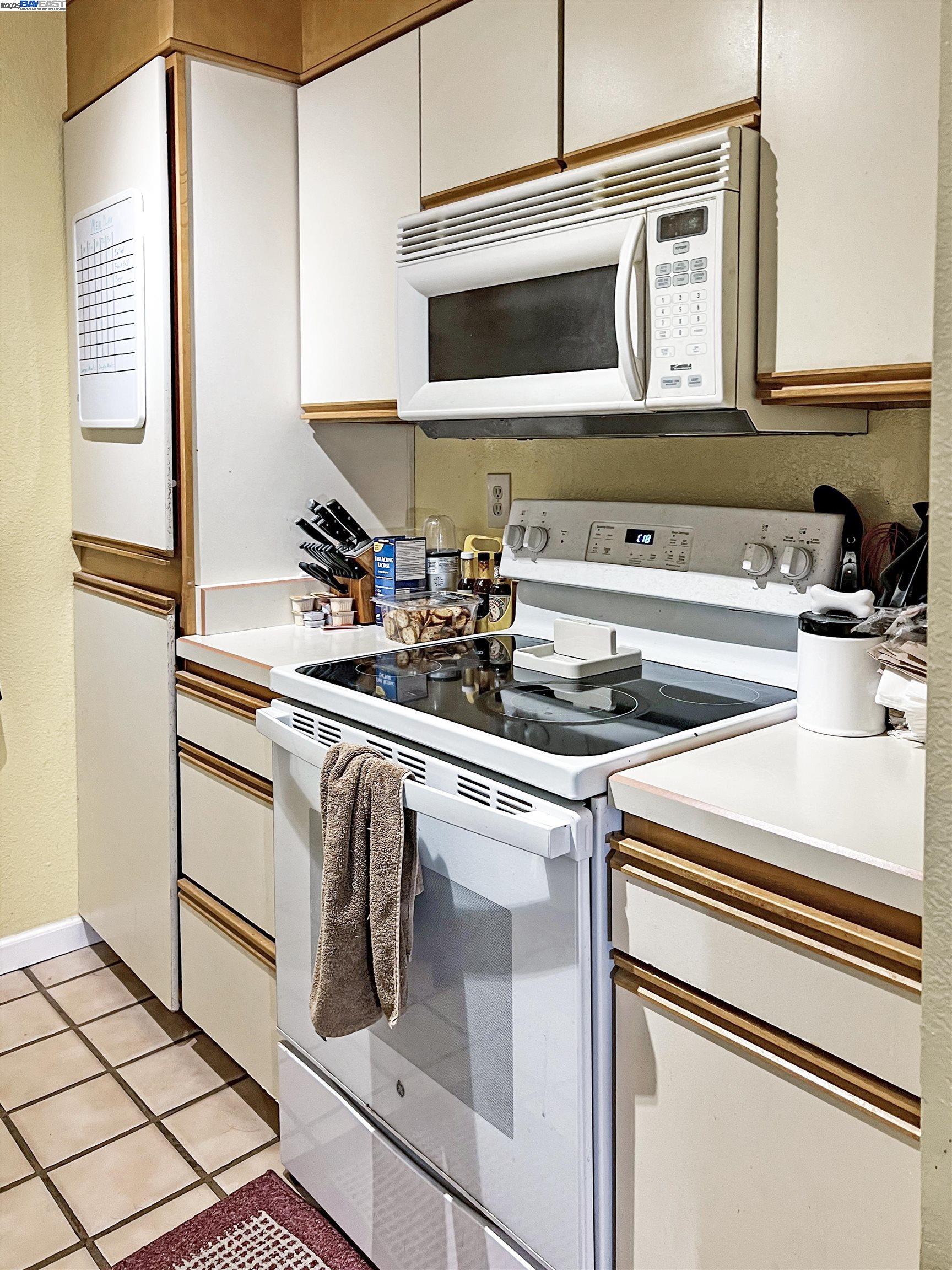 1310 Walden Road, Unit 11 Walnut Creek, CA 94597 - Photo 6 of 26 a kitchen with a stove and a microwave