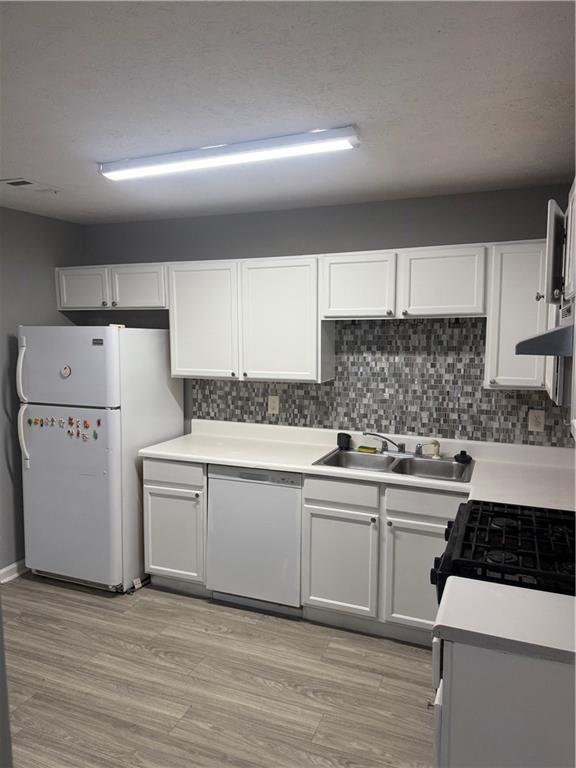 6341 Wedgeview Drive Tucker, GA 30084 - Photo 7 of 26 a kitchen with white cabinets and white appliances