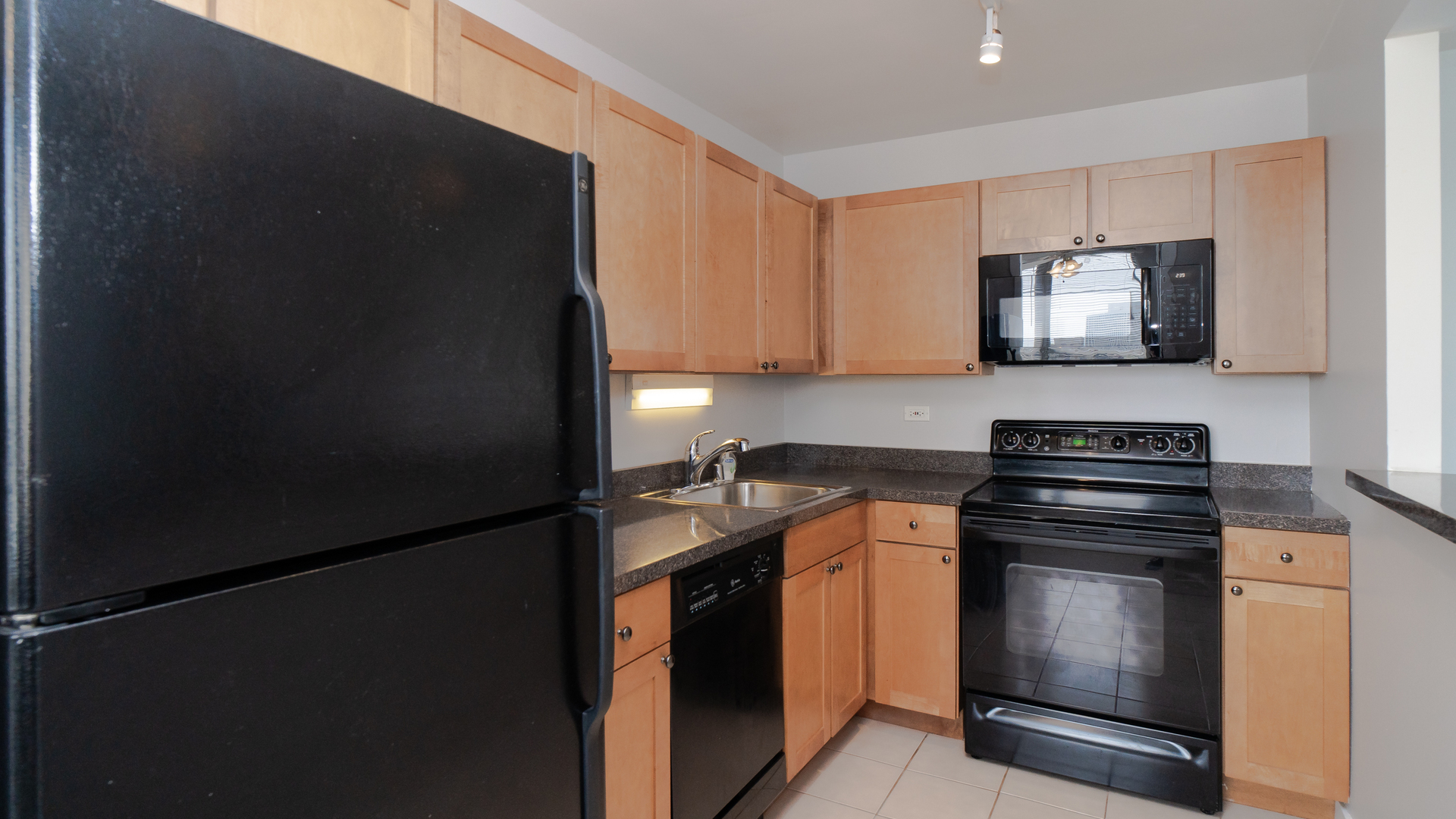 655 West Irving Park Road, Unit 803 Chicago, IL 60613 - Photo 7 of 25 a kitchen with stainless steel appliances granite countertop a stove and a refrigerator