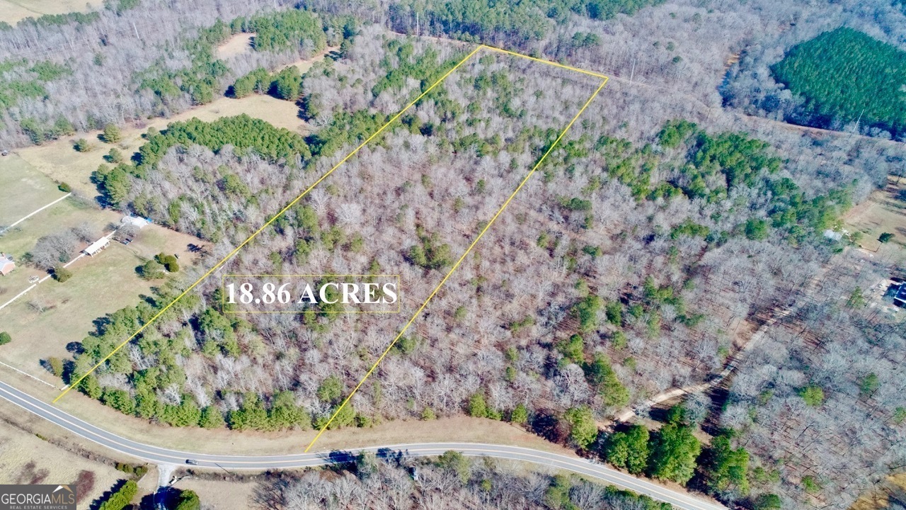 a view of a yard with wooden fence