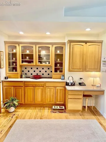 a view of a kitchen with granite countertop a sink and a white cabinets