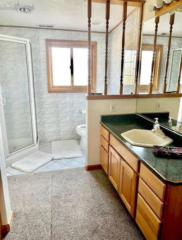 a bathroom with a granite countertop sink a mirror and a bathtub