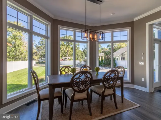 a living room with furniture a fireplace and a large window