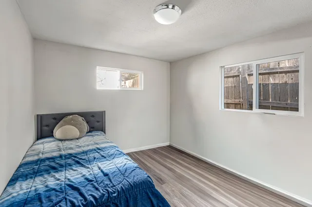 a view of a wooden house with a large tree