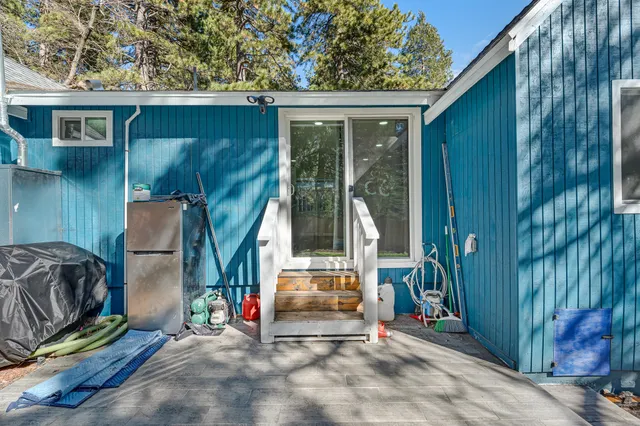 a view of a house with a tree in front of it