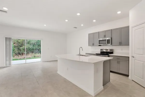 a kitchen with stainless steel appliances a sink stove and cabinets