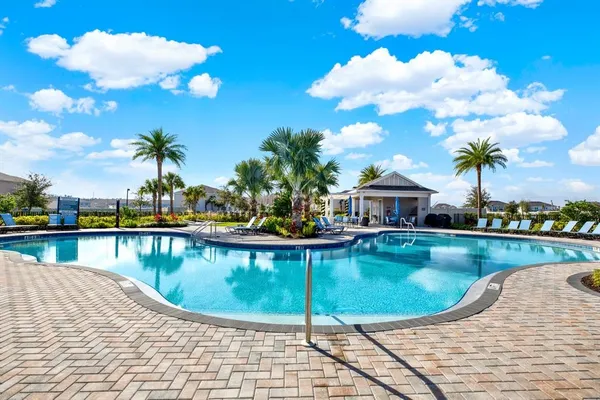 an aerial view of a house outdoor space and swimming pool