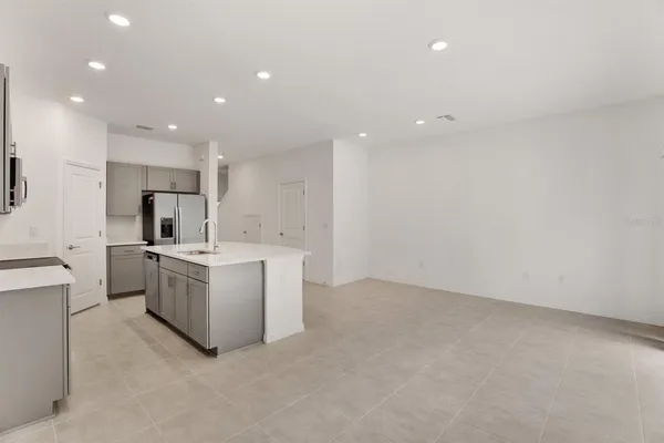 a kitchen with sink and white cabinets