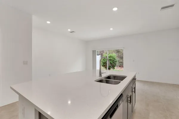 a kitchen with a sink and a refrigerator