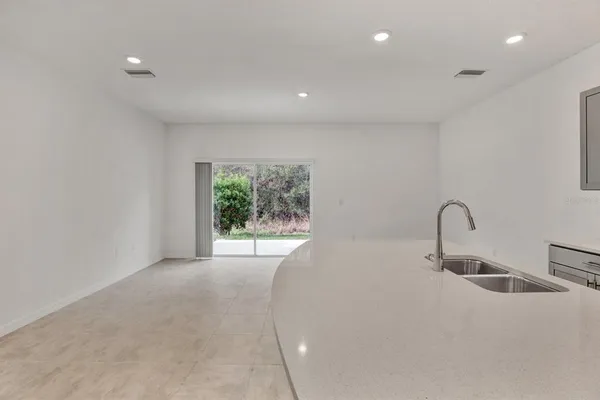 a kitchen with kitchen island a sink appliances and a window