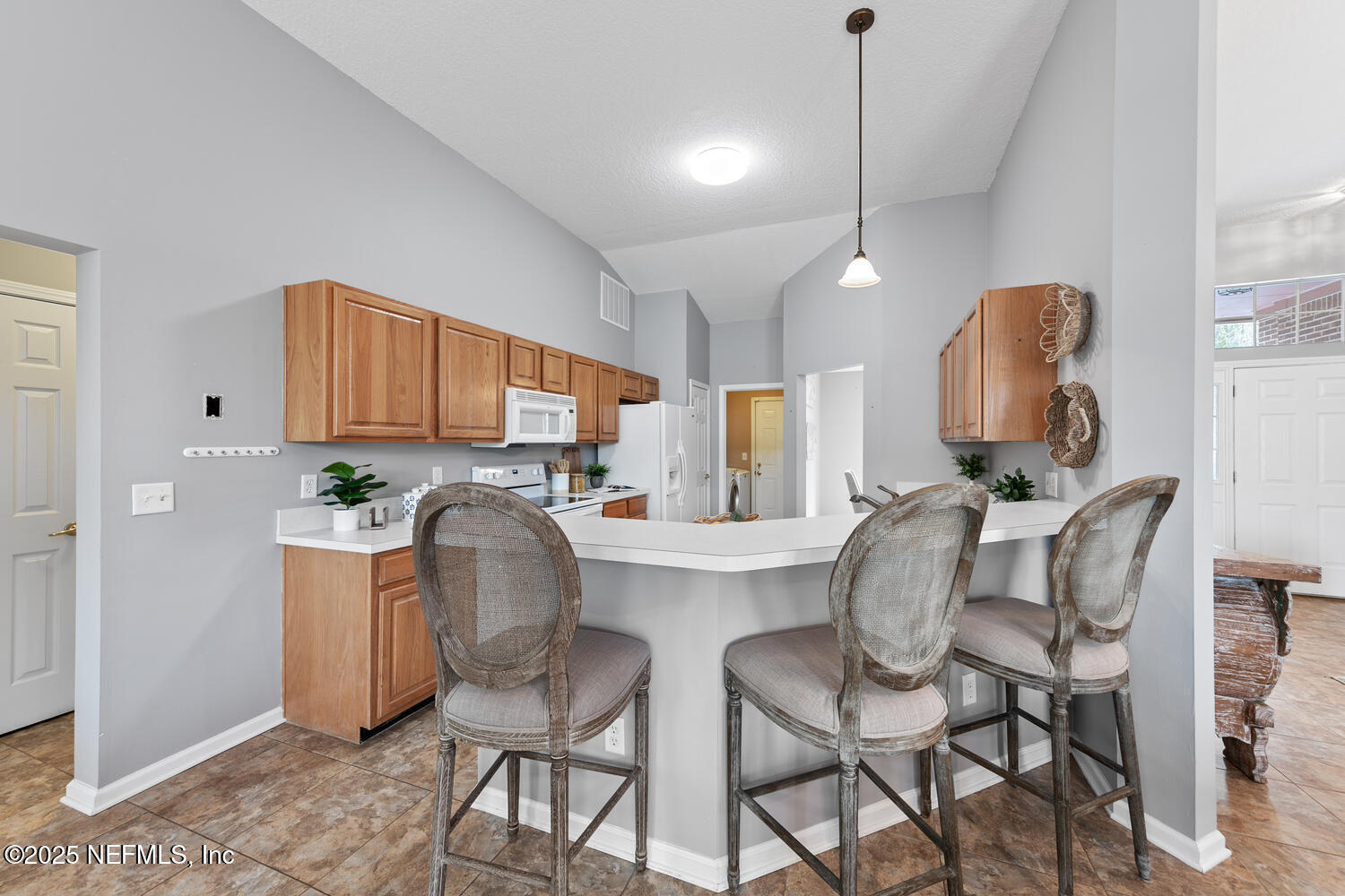 113 Nottingham Drive St. Johns, FL 32259 - Photo 13 of 35 a kitchen with granite countertop a table chairs stove and refrigerator