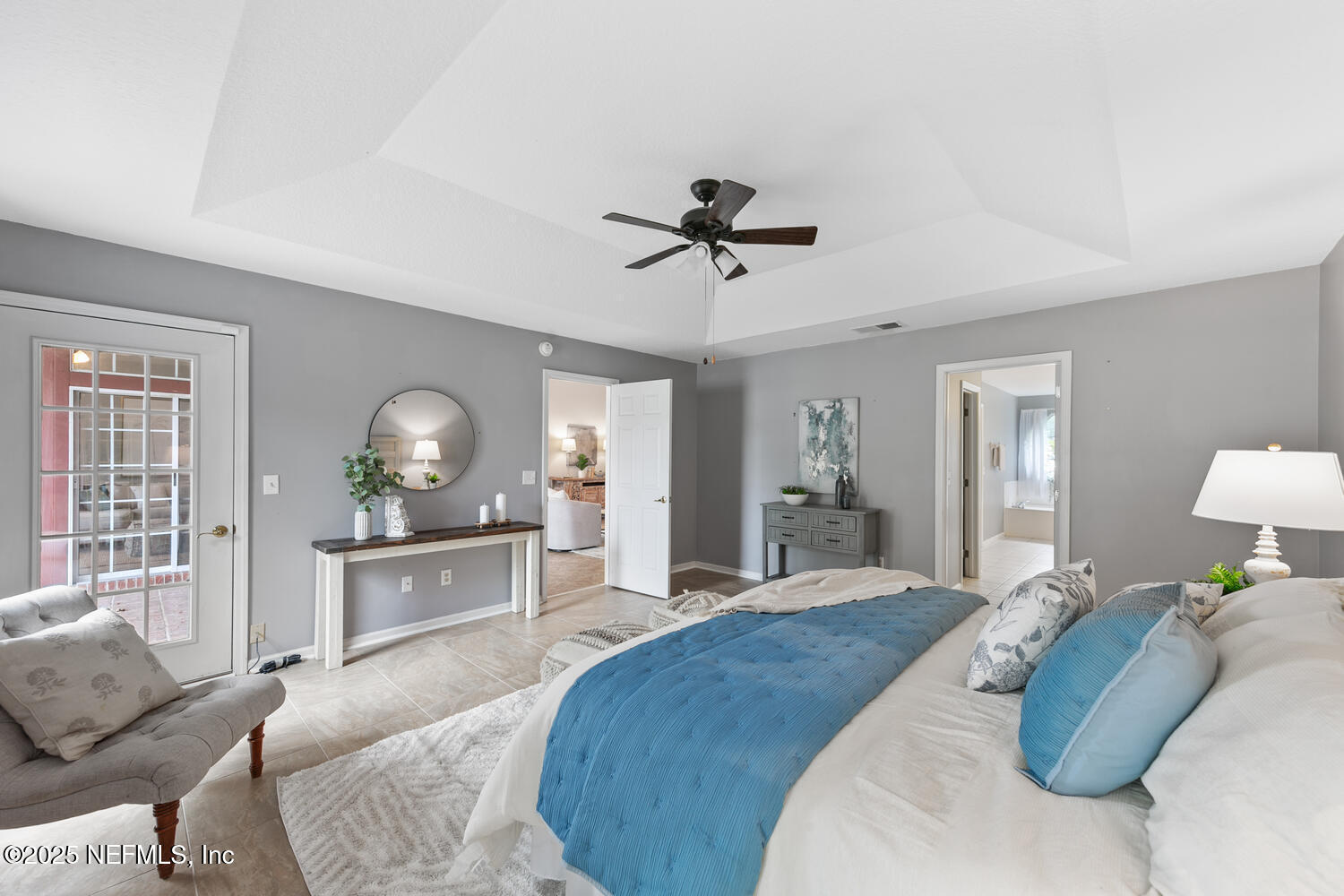 113 Nottingham Drive St. Johns, FL 32259 - Photo 19 of 35 a spacious bedroom with a bed a chandelier and mirror