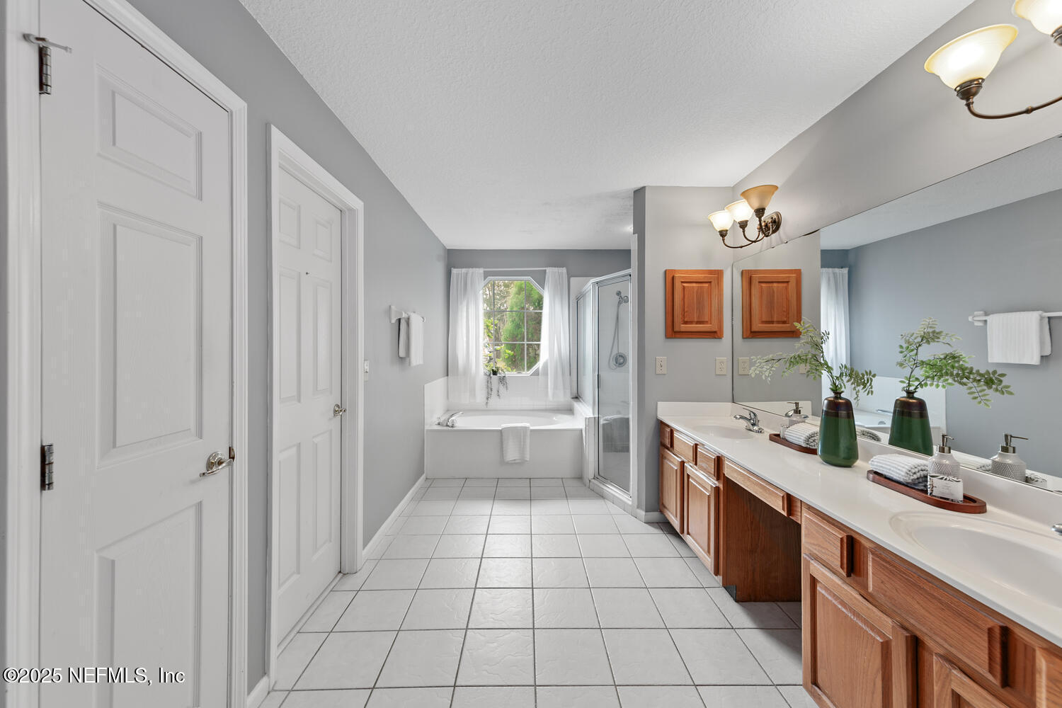 113 Nottingham Drive St. Johns, FL 32259 - Photo 20 of 35 a large white bathroom with a granite countertop double vanity sink a mirror and a bathtub