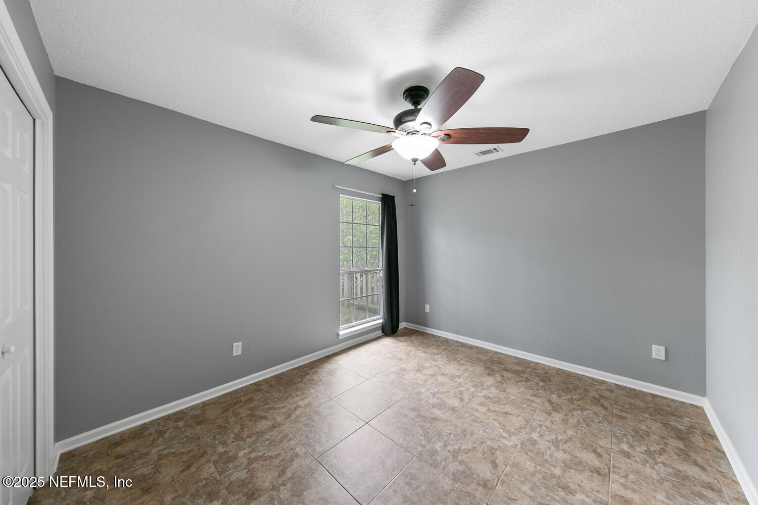 113 Nottingham Drive St. Johns, FL 32259 - Photo 25 of 35 an empty room with a chandelier fan and windows