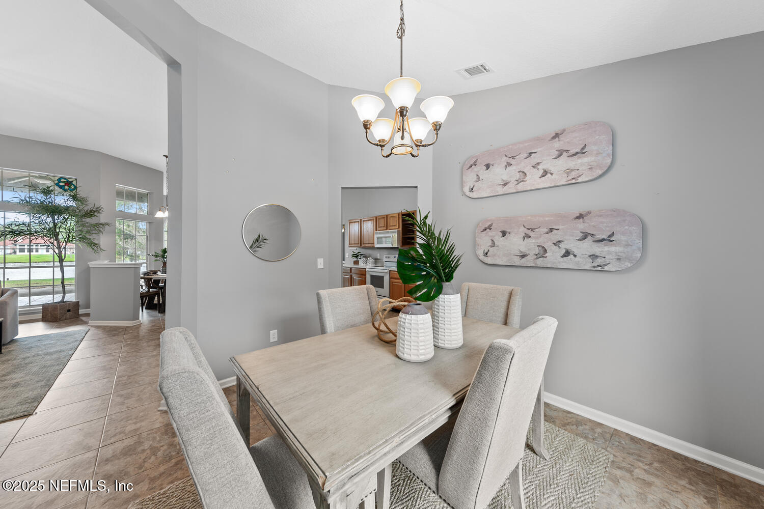 113 Nottingham Drive St. Johns, FL 32259 - Photo 8 of 35 a dining room with wooden floor a chandelier a wooden table and chairs