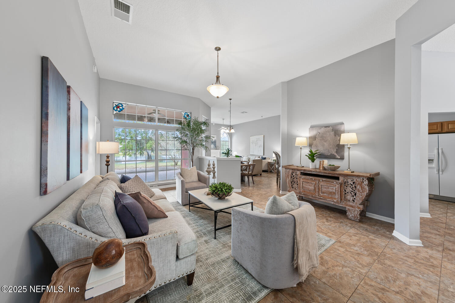 113 Nottingham Drive St. Johns, FL 32259 - Photo 9 of 35 a living room with furniture and a chandelier
