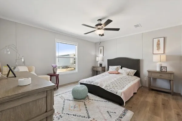 a bedroom with a bed and wooden floor
