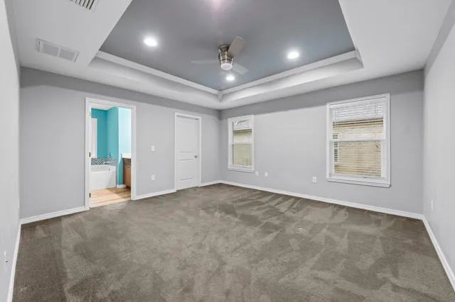 an empty room with windows and cabinet