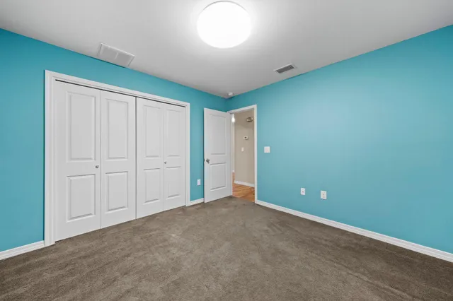 an empty room with closet area