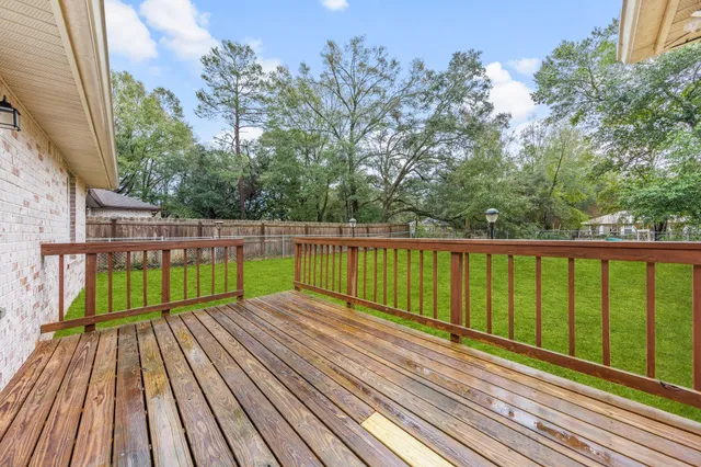 a view of wooden deck with a large trees