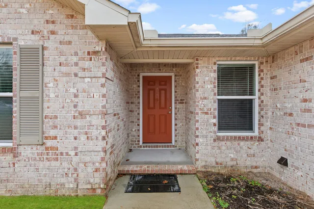 a view of a brick house with many windows