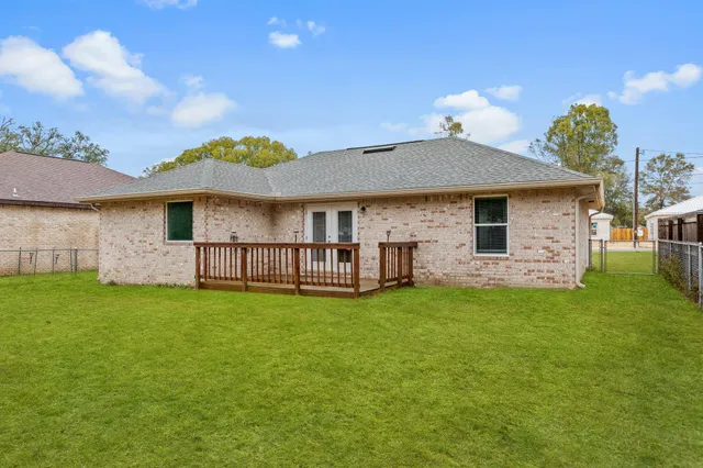 a view of a house with a yard and sitting area