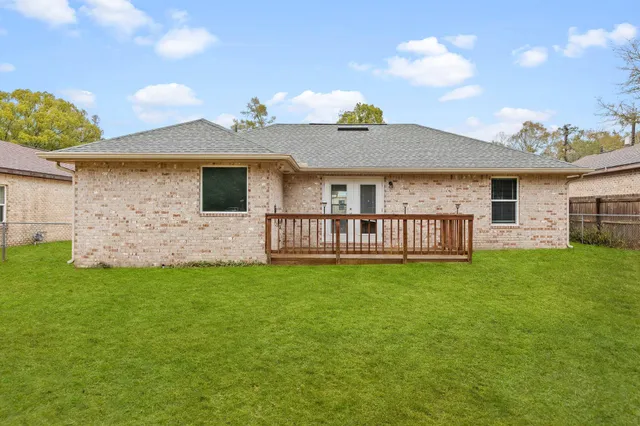 a view of a house with a yard and a garden