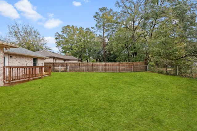 a view of a house with backyard and sitting area