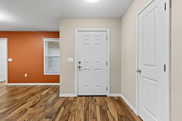 a view of a room with wooden floor and bathroom