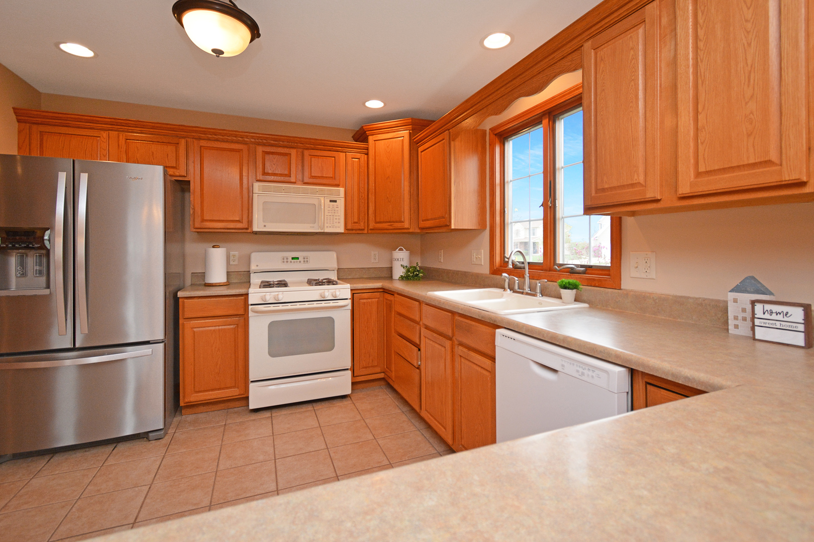 2884 Bear Claw Street Normal, IL 61761 - Photo 16 of 62 a kitchen with a refrigerator sink and cabinets