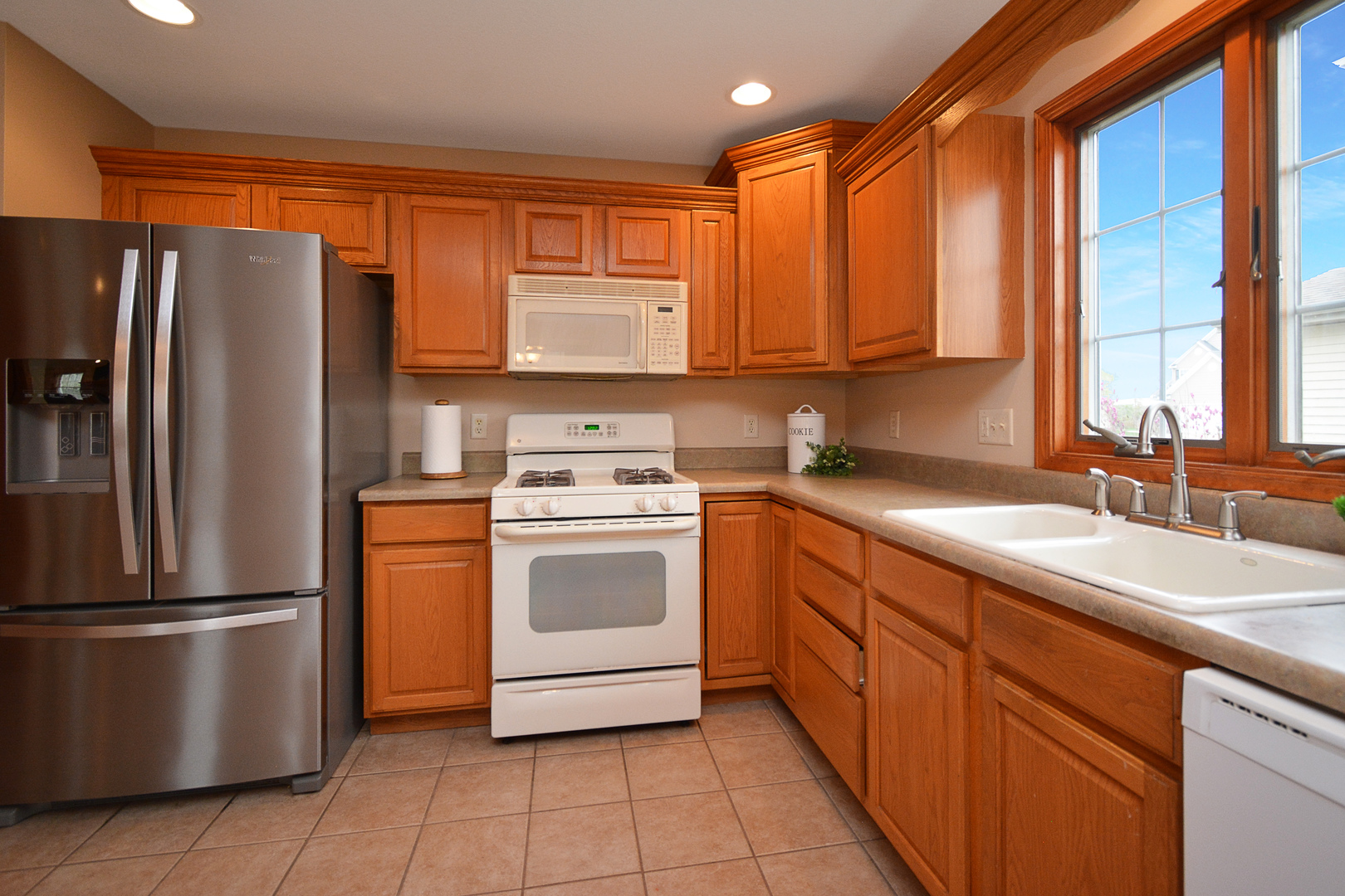 2884 Bear Claw Street Normal, IL 61761 - Photo 17 of 62 a kitchen with stainless steel appliances granite countertop a refrigerator a sink a stove top oven and a refrigerator