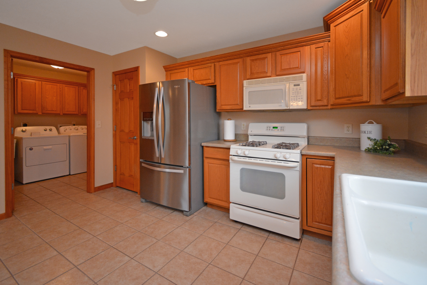 2884 Bear Claw Street Normal, IL 61761 - Photo 23 of 62 a kitchen with white cabinets and white appliances
