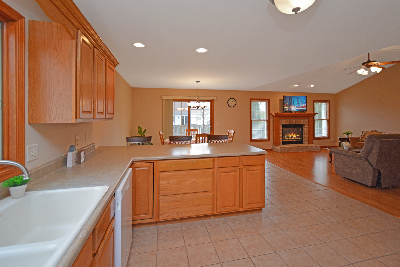 2884 Bear Claw Street Normal, IL 61761 - Photo 24 of 62 a large kitchen with stainless steel appliances granite countertop a sink and dishwasher stove with wooden cabinets