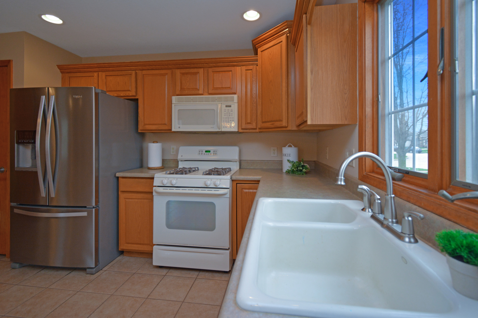 2884 Bear Claw Street Normal, IL 61761 - Photo 26 of 62 a kitchen with stainless steel appliances granite countertop a refrigerator sink and stove