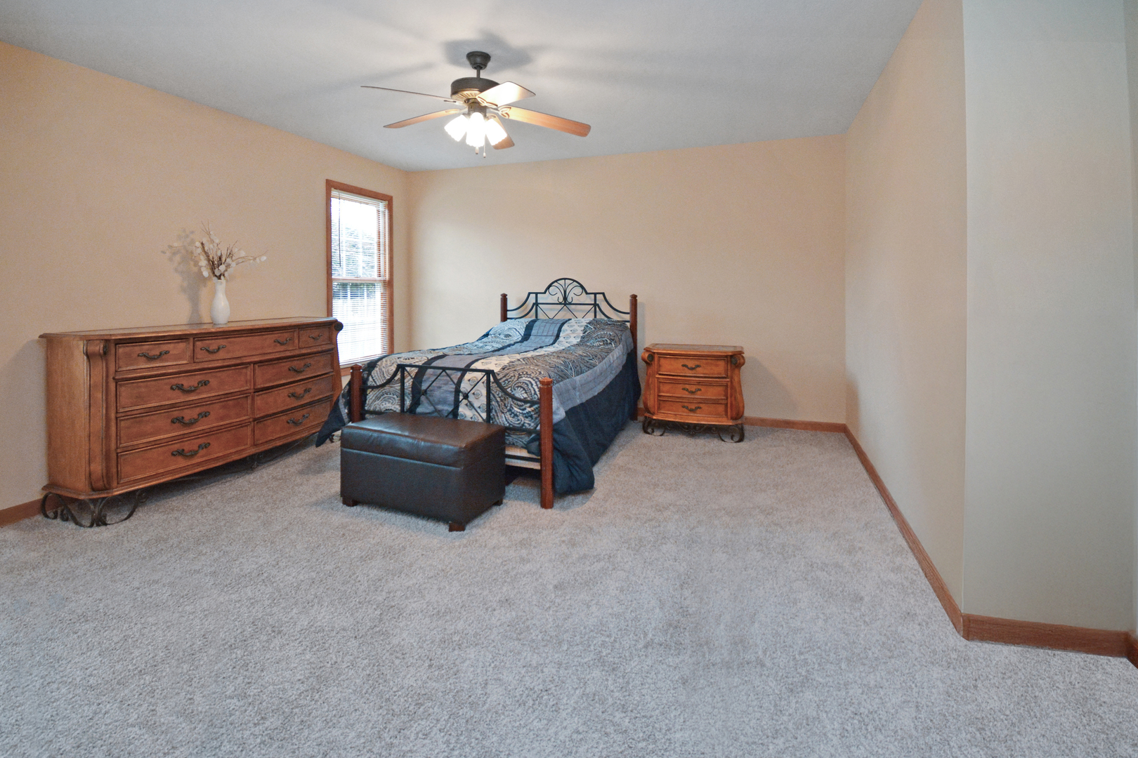 2884 Bear Claw Street Normal, IL 61761 - Photo 30 of 62 a spacious bedroom with a bed and a chandelier