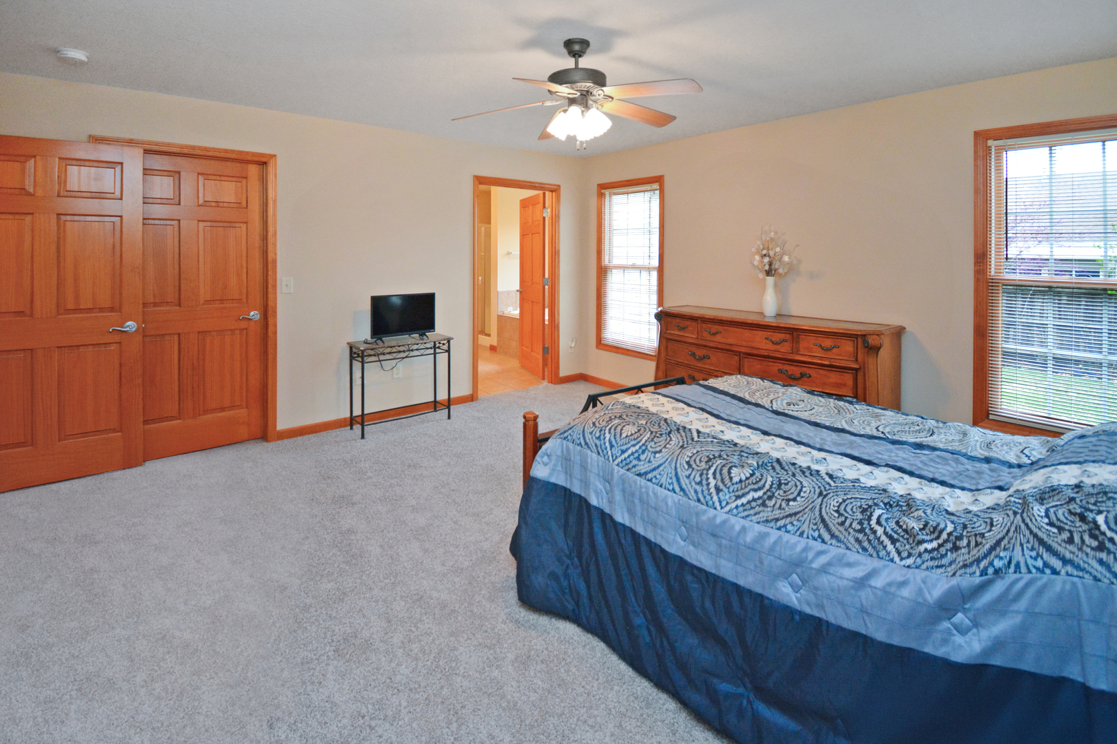 2884 Bear Claw Street Normal, IL 61761 - Photo 33 of 62 a bedroom with a large bed chandelier and a window