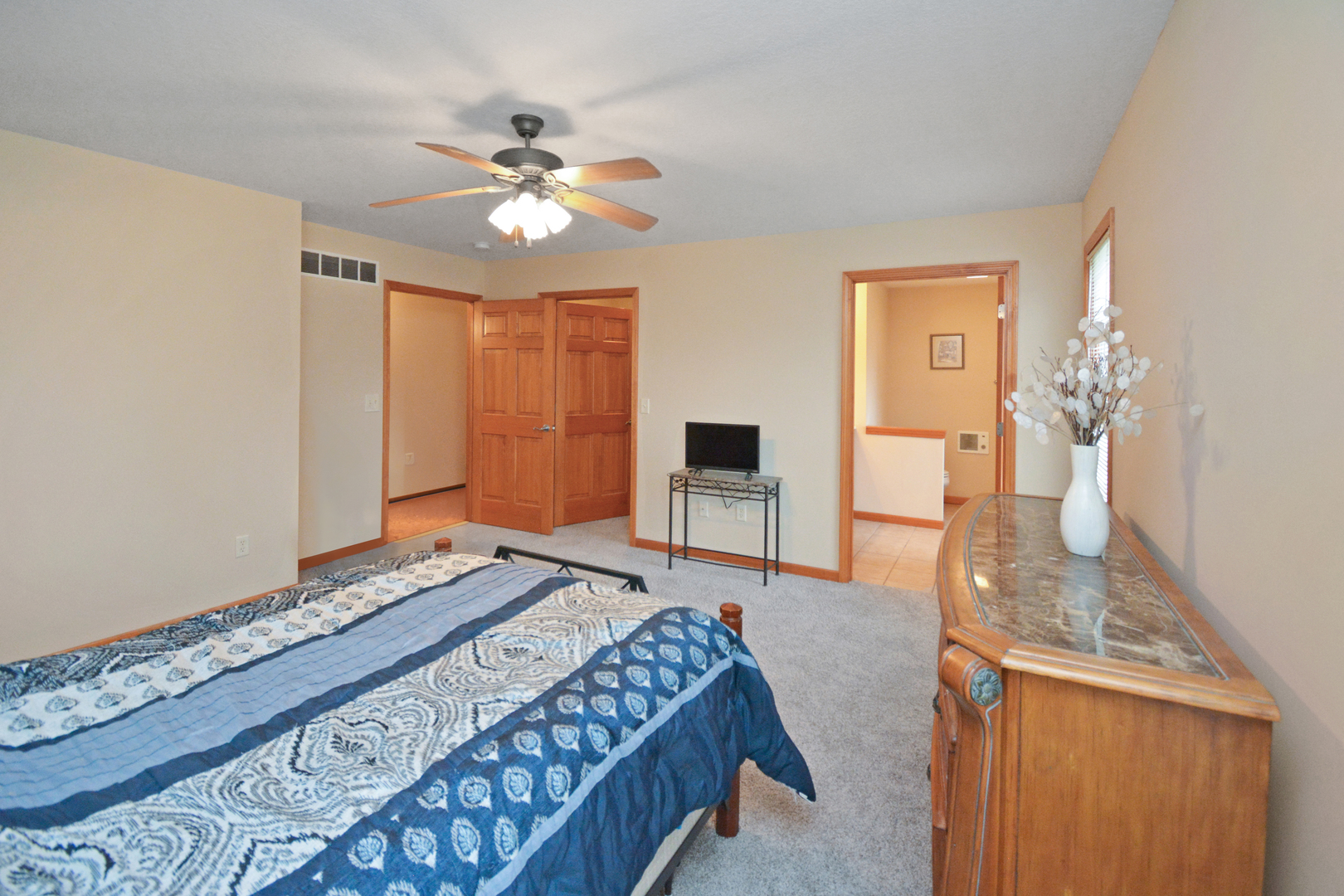 2884 Bear Claw Street Normal, IL 61761 - Photo 34 of 62 a bedroom with a bed and a chandelier