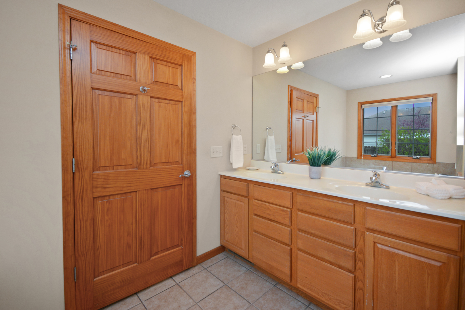 2884 Bear Claw Street Normal, IL 61761 - Photo 42 of 62 a bathroom with a double vanity sink and a mirror