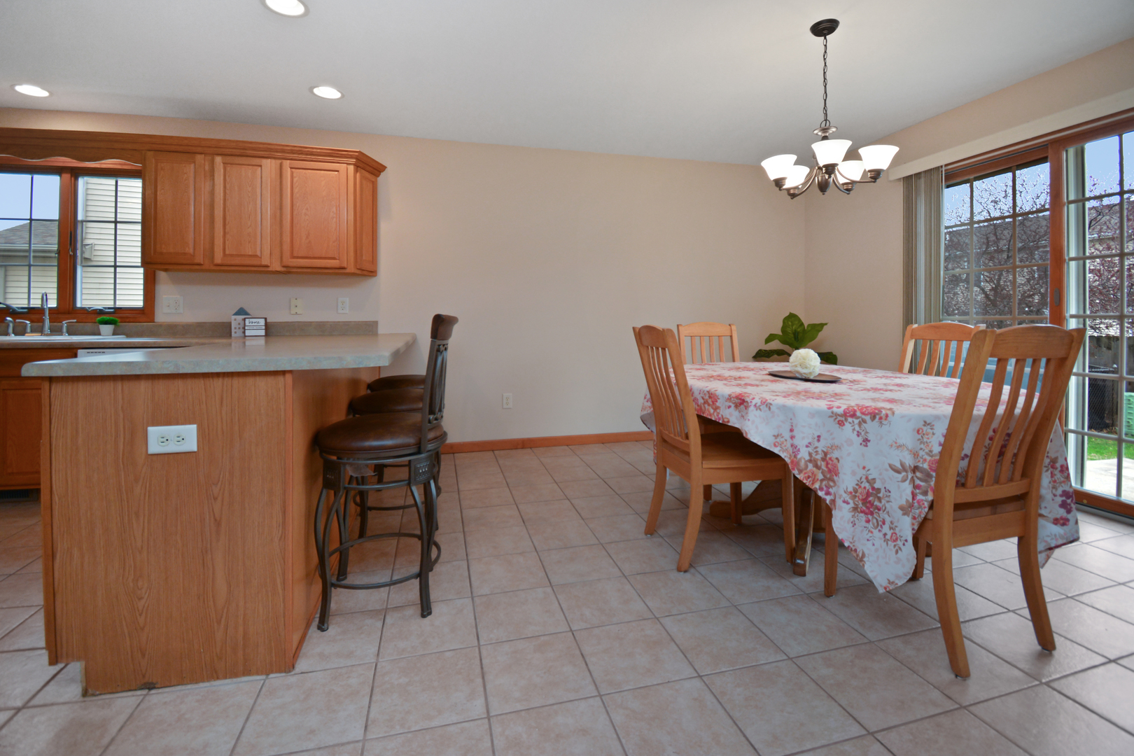 2884 Bear Claw Street Normal, IL 61761 - Photo 56 of 62 a dining room filled chandelier and kitchen view