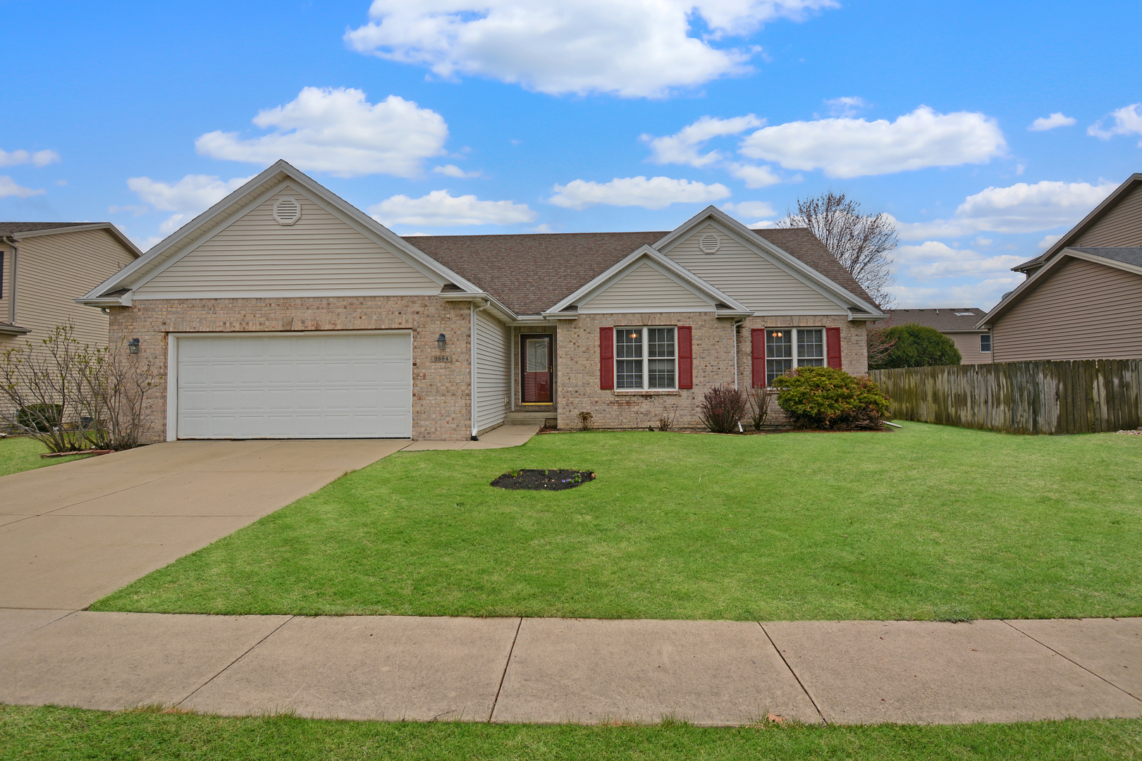 2884 Bear Claw Street Normal, IL 61761 - Photo 62 of 62 a front view of a house with a yard and garage