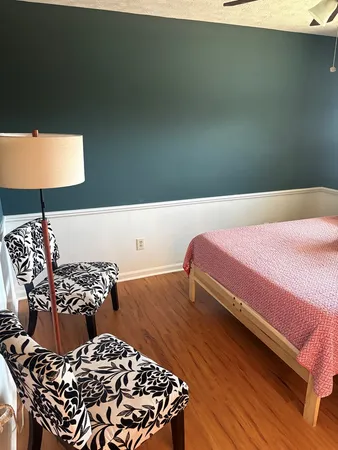 a bedroom with a bed and a night stand