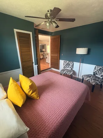 a bedroom with a bed and a lamp