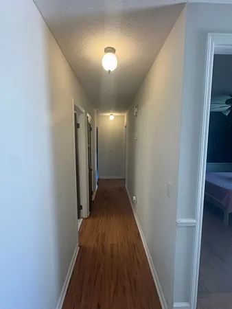 a view of hallway with wooden floor