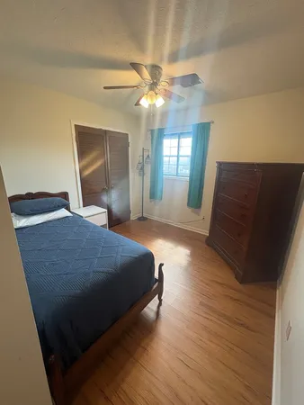 a bedroom with a large bed and a chandelier