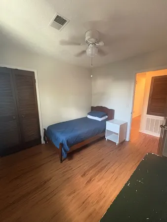 a view of a room with furniture and wooden floor