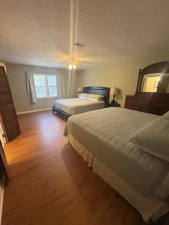 a bedroom with two beds and a tv
