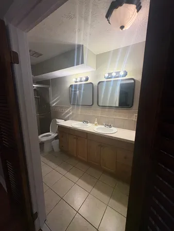 a bathroom with a sink a toilet and a shower