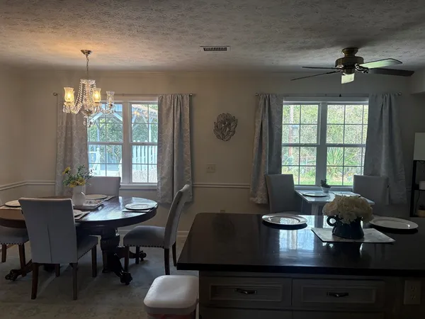 a view of a dining room with furniture window and outside view