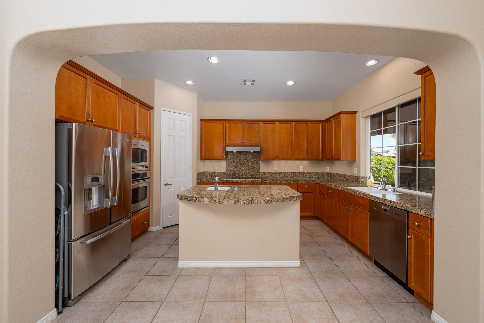 14 Via Santo Tomas Drive Rancho Mirage, CA 92270 - Photo 24 of 61 a kitchen with stainless steel appliances granite countertop a refrigerator and a stove