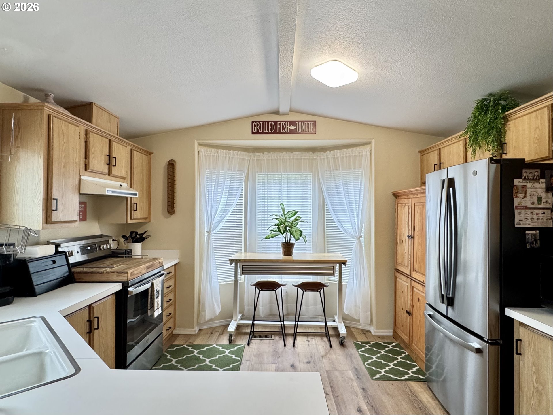 3760 Highway 101, Unit 1 Florence, OR 97439 - Photo 19 of 32 a kitchen with stainless steel appliances a stove a refrigerator and a sink